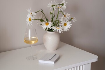 Refreshing Vision A Beautiful Bunch of Pure White Daisies Alongside a Glass of Fine Wine