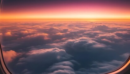 Beautiful sunset sky with clouds viewed through an airplane window