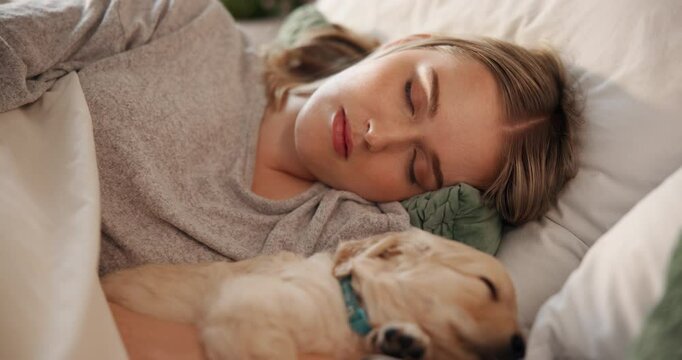 Dog, sleeping or rest in bedroom with woman, tired and stress relief with pet for comfort. Asleep, dreaming and break with puppy and female owner, relax or nap for fatigue with cuddling at house