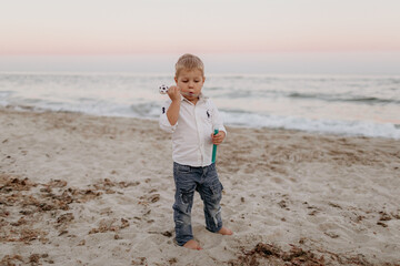 little boy at sea on the beach in summer