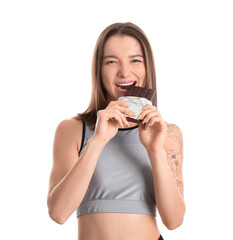 Young woman eating sweet chocolate bar on white background