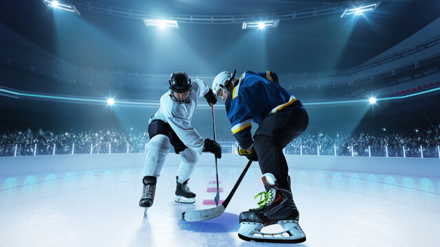 Two players in full gear preparing for face-off as the puck is about to drop, on 3D ice rink. Concept of professional sports coverage, sportsmanship and sports preparation