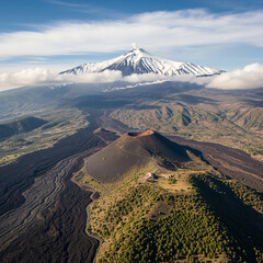 Aerial view of majestic volcano with snow-capped peak and solidified lava fields, demonstrating the power of nature. Ideal for geology, travel, nature and adventure themes.