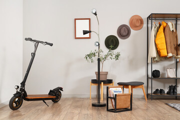 Interior of stylish hall with electric scooter and coat rack