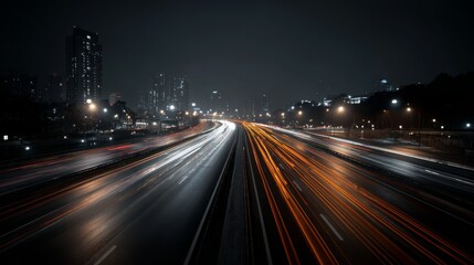 A night scene of an expressway with headlights from cars and streetlights illuminating the road, showcasing the fast pace of city life after dark