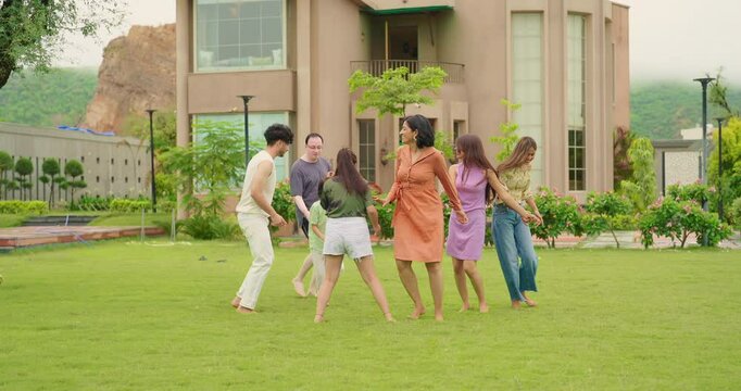 Indian happy family group play game running with cute son kid boy enjoy day outdoor home park Adult mom dad man woman young male female teen girl child have fun joy spend time at outside garden house - Powered by Adobe