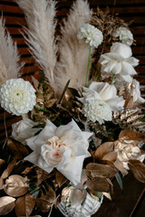 Elegant floral arrangement with roses, pampas, and delicate foliage