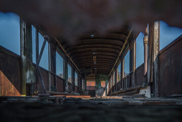 
NARROW GAUGE DIESEL RAILCAR - The interior of an old, rusty wreck of a passenger transport vehicle
