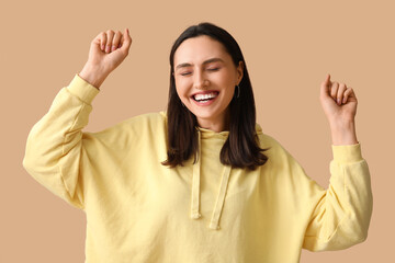 Smiling young woman on brown background