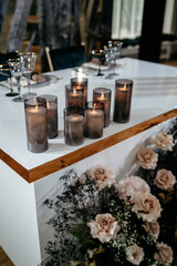 Elegant table setting with candles and floral arrangement for intimate gathering