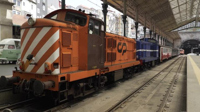 View of an old CP train parked at S&atilde;o Bento train station in porto, steady camera, no people around. Old locomotive.