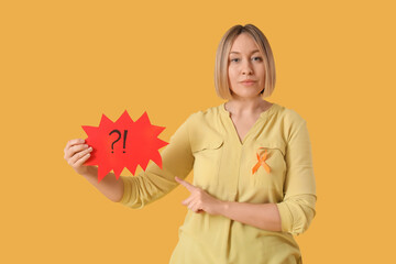 Mature woman with ribbon pointing at speech bubble on yellow background. Multiple Sclerosis...