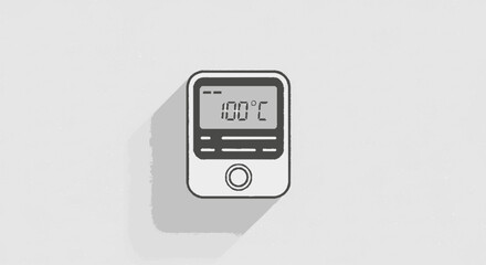 A digital thermometer displays 100 degrees Celsius, casting a long shadow on the surface.