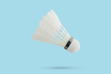 Badminton shuttlecock floating on blue background