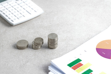 Coins and objects on a table with a financial and economic concept.