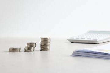 Coins and objects on a table with a financial and economic concept.