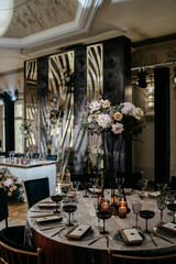 Elegant reception table with floral centerpiece and modern decor in luxurious venue setting