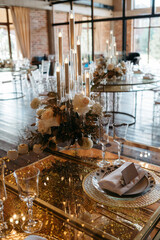 Elegant candlelit table setting with roses and glassware for formal event