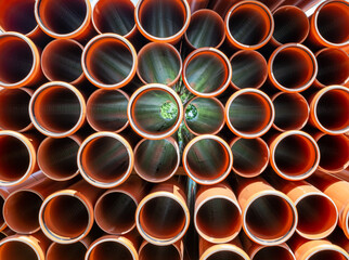 Stack of Orange pipe made of polyvinyl chloride