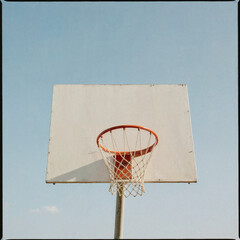 Minimalist Basketball Hoop Against Bright Blue Sky