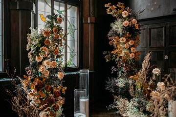 Elegant floral arrangement in vintage interior with stained glass and wood panels