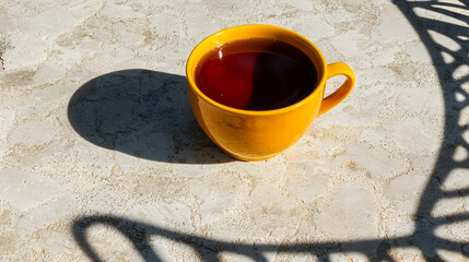 Sunny morning tea on patio, shadow of metal chair, relaxing outdoor scene, perfect for breakfast or brunch blogs