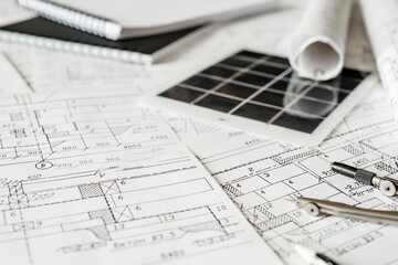 sustainable architecture tools and materials: blueprints, solar panel, wood textures, fabric...