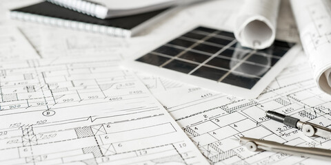 sustainable architecture tools and materials: blueprints, solar panel, wood textures, fabric...
