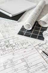 sustainable architecture tools and materials: blueprints, solar panel, wood textures, fabric...