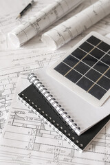 sustainable architecture tools and materials: blueprints, solar panel, wood textures, fabric...