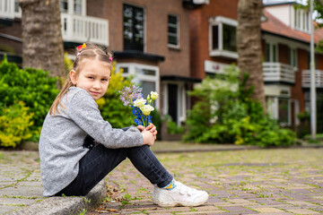 Photo of happy smiling girl child kid school pupil spending time summer holiday having fun meeting hanging out outside in green nature park looking at camera