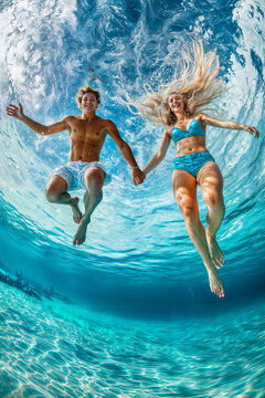 Young man and woman jumping into water. Shot on fish-eye camera. Vertical layout. Immersive POV