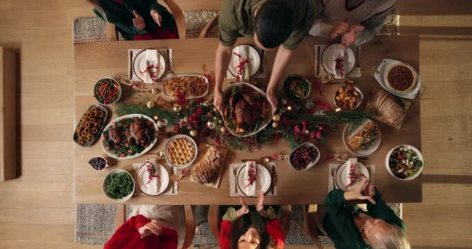 Applause, family and Christmas dinner in home for festive celebration, event or party together. Food, top view and people in dining room with clapping hands for gourmet meal, feast or supper for xmas