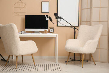 Interior of recording studio with workplace, armchairs and microphone