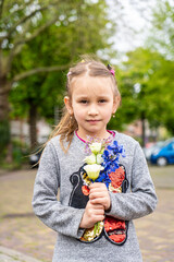 Photo of happy smiling girl child kid school pupil spending time summer holiday having fun meeting hanging out outside in green nature park looking at camera