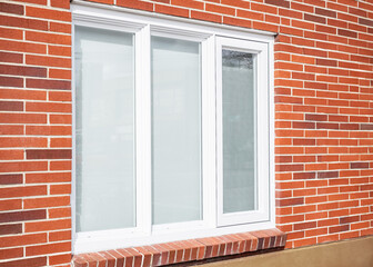 Real modern house window frame in a new brick house.