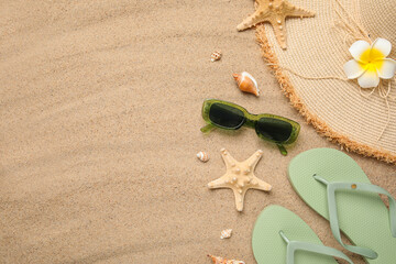 Summer composition with seashells, starfish and beach accessories on sand as background