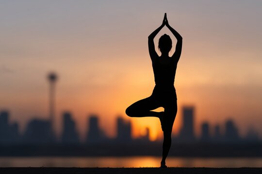 Yoga tree pose at sunrise city skyline, Woman silhouette meditating outdoor morning, Healthy body mind balance concept