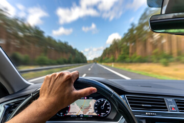 Hand on wheel. Driving highway. Map navigation on dashboard.