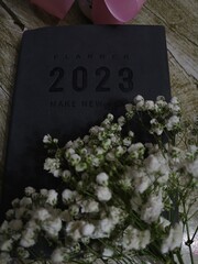 grave stone cross,notebook,flowers