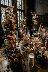Vintage floral arrangement in elegant indoor setting with stained glass windows