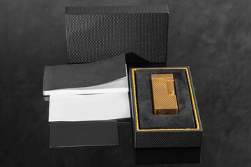 Branded gold lighter in a box. Rare item. Office interior.