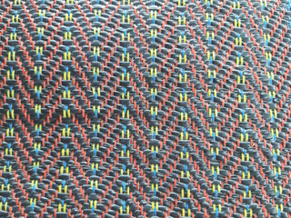 Colorful beads form an abstract, textured pattern, creating a vibrant textile design for a unique...