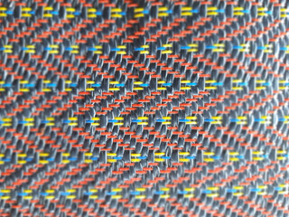 Colorful beads form an abstract, textured pattern, creating a vibrant textile design for a unique...
