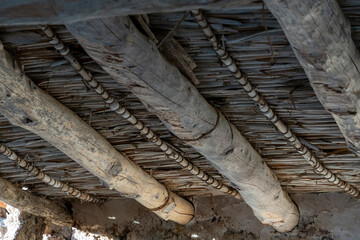 A wooden beam with a pattern of beads on it