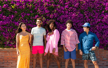 Multiethnic group of young happy friends bonding outside, having fun on summertime vacation -...