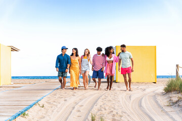 Multiethnic group of young happy friends bonding outside, having fun on summertime vacation -...