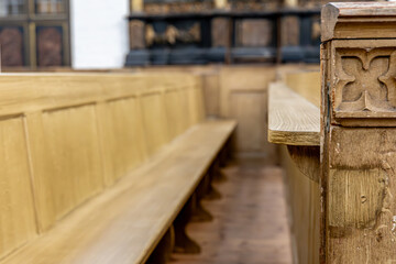 Carved wooden benches. Gothic church interior. Vintage atmosphere