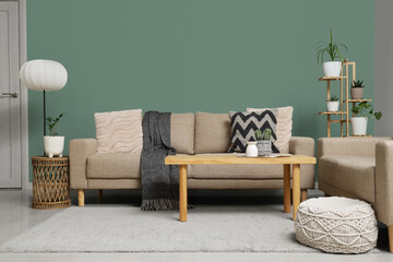 Comfortable sofas, pouf and table in interior of living room, closeup