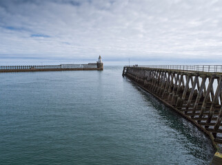 Entrance to Port of Blyth with piers and lighthouse, Northmberland, UK